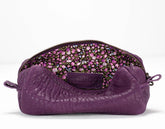 Purple textured pouch with floral patterned interior on a white background