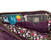 Floral-patterned wallet with cards inside on a white background
