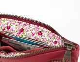 Floral-patterned wallet with visible cards on a white background