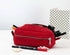 Red cotton pencil case with stationery items on a white background