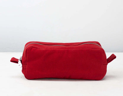 Red cotton toiletry bag with zippers on a white background