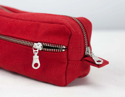 Red cotton pouch with silver zippers on a white background