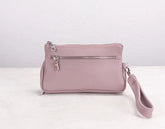 Pink handbag with a strap on a white background
