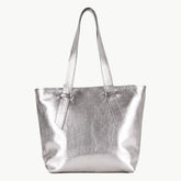 A metallic silver tote bag with two shoulder straps, shown against a plain off-white background.