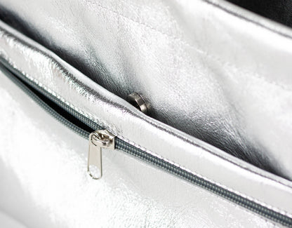 Close-up of a silver metallic bag with a zipper