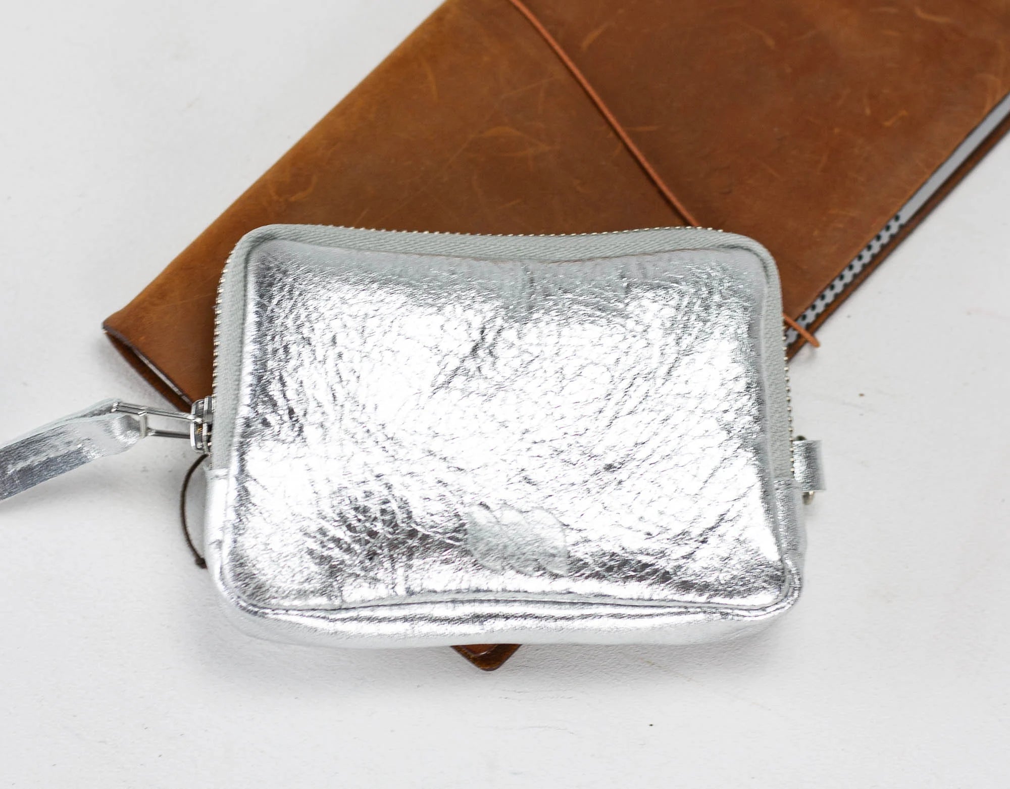 Silver pouch with a textured surface on a white background