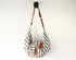 Striped bag with brown leather straps on a white background