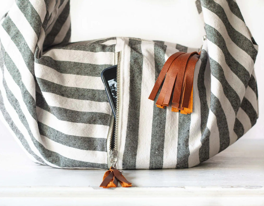 Striped bag with leather tassels on a white background