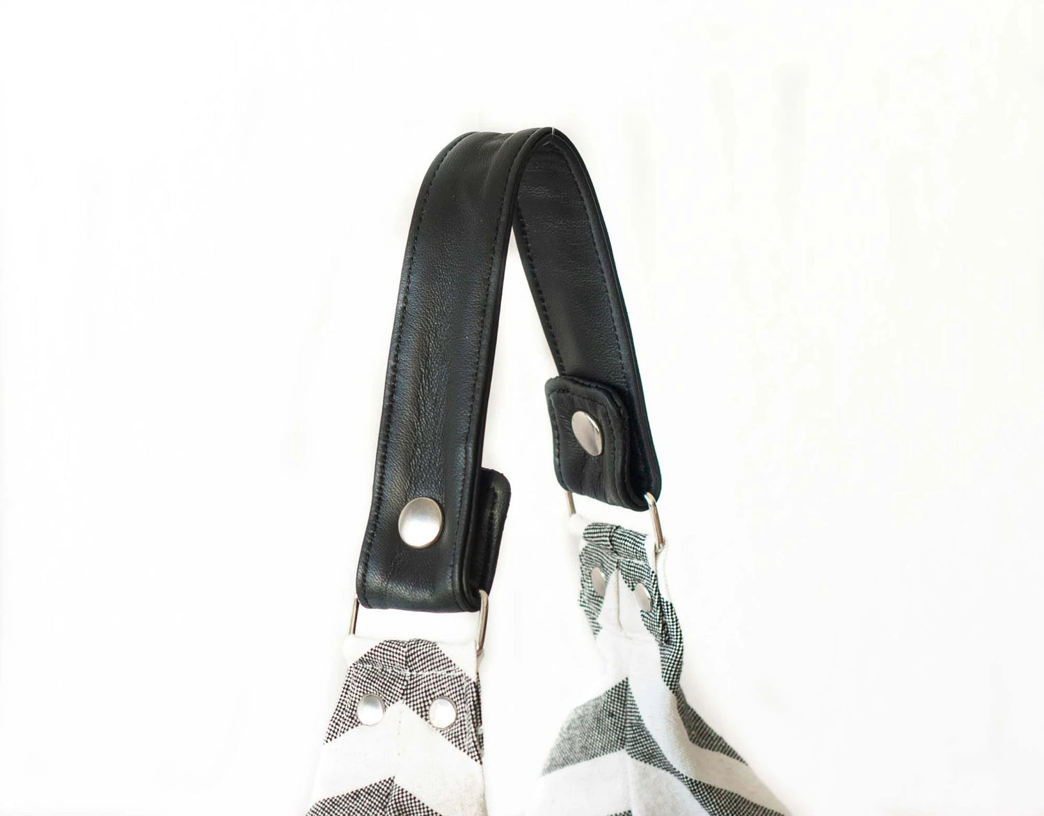Black strap with metal buckles on a white background