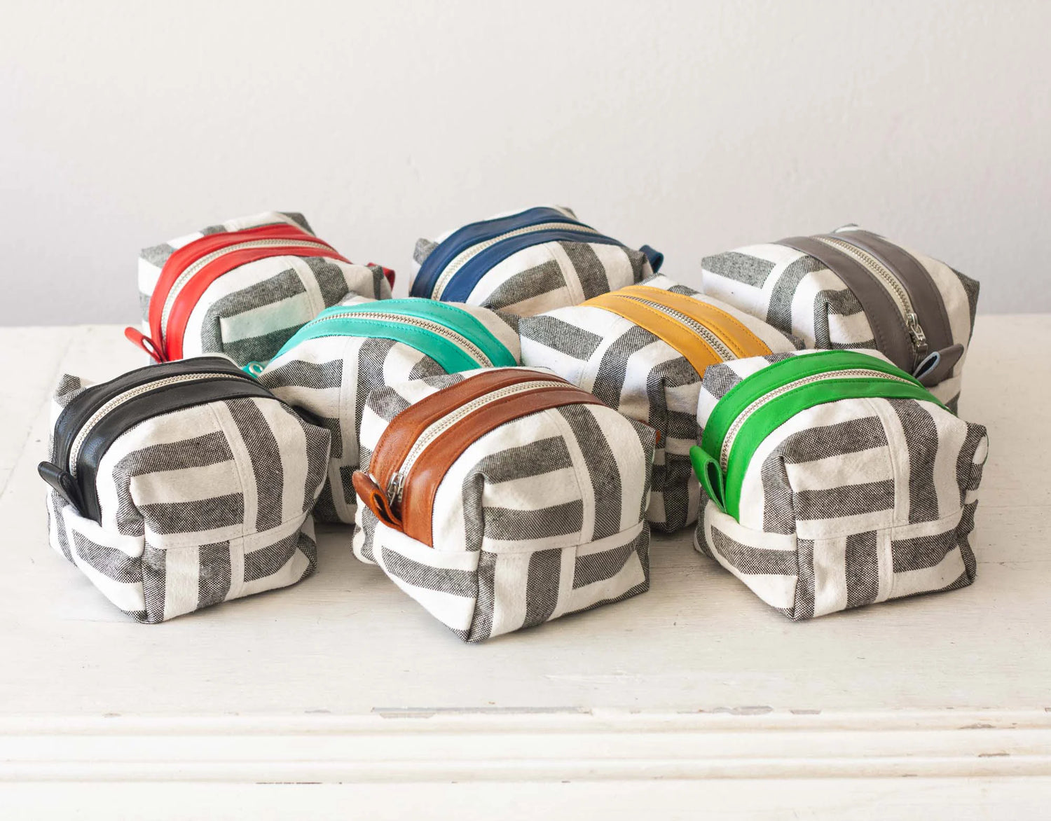 Set of small fabric pouches with geometric patterns on a white surface