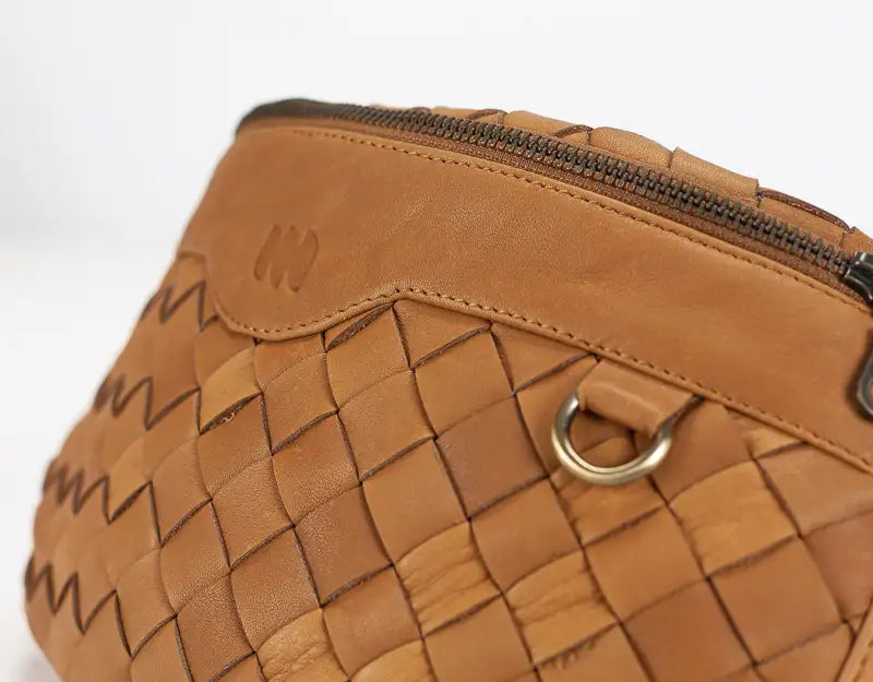 Brown woven handbag with a gold clasp on a white background