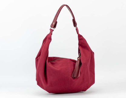 Red handbag with a tassel on a white background
