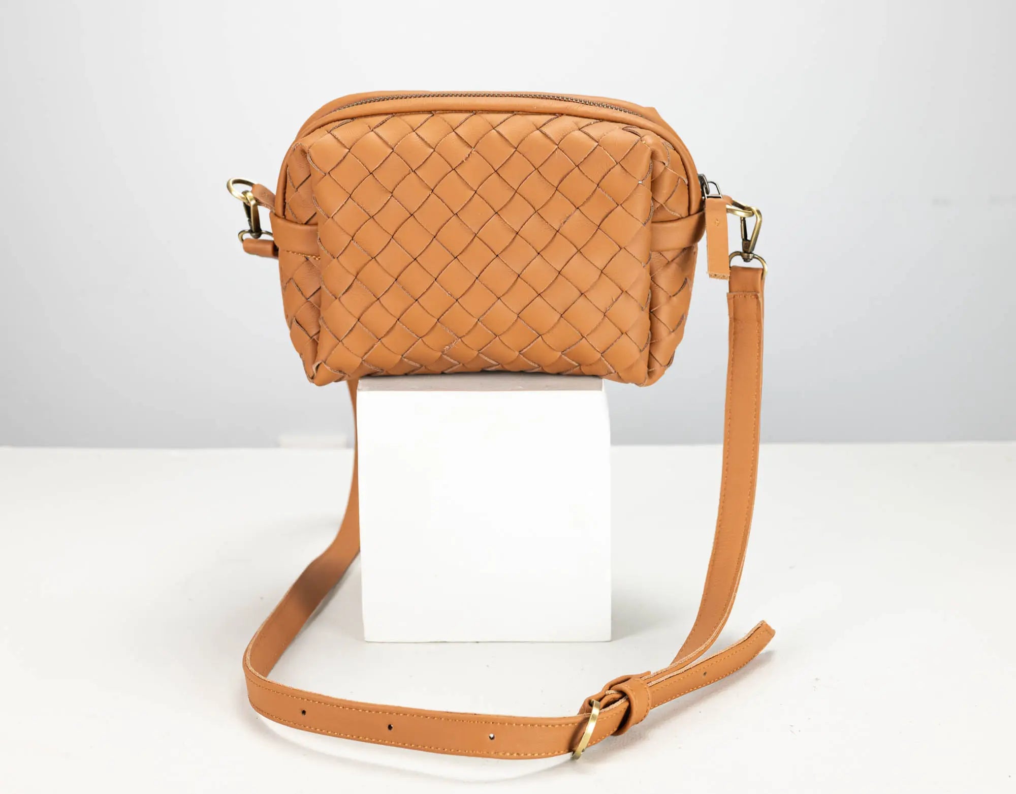 a brown leather woven bag 
