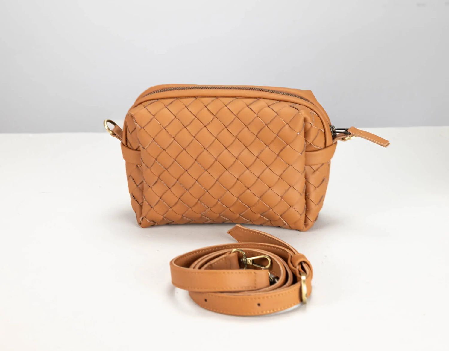 a brown leather woven bag by milloobags