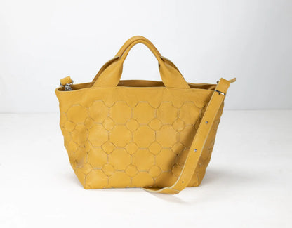 Yellow handbag with honeycomb pattern on a white background