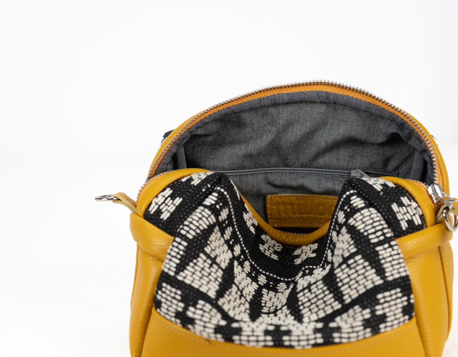 Yellow handbag with a patterned handle on a white background