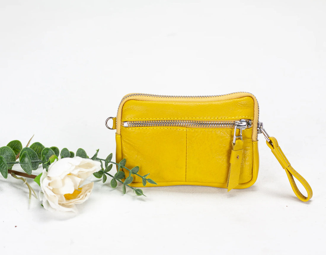Yellow leather wallet with card slots on a white background